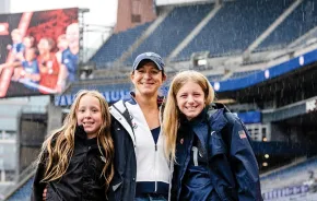 stephanie cox with her daughters in the field