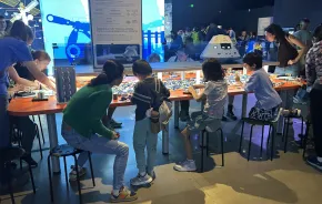 families building with Lego bricks at the 'Artemis Adventure with Lego Bricks'