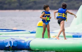 Children playing on inflatable floating water park