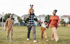 A happy African American family hold hands as they celebrate Juneteenth.