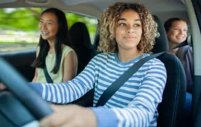 teen girls driving in a car