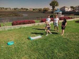 people playing Flyball game outside on the lawn