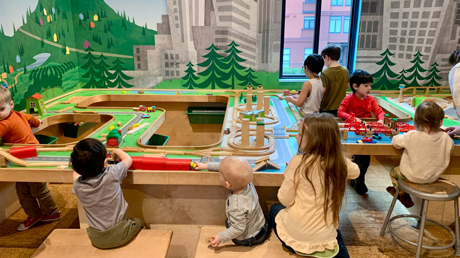 kids playing at the train table at KidsQuest Children's Museum, a Bellevue attraction for kids