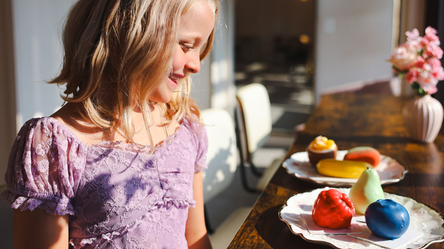 girl looking at fruit-shaped desserts from Ladun, a unique shop in Everett