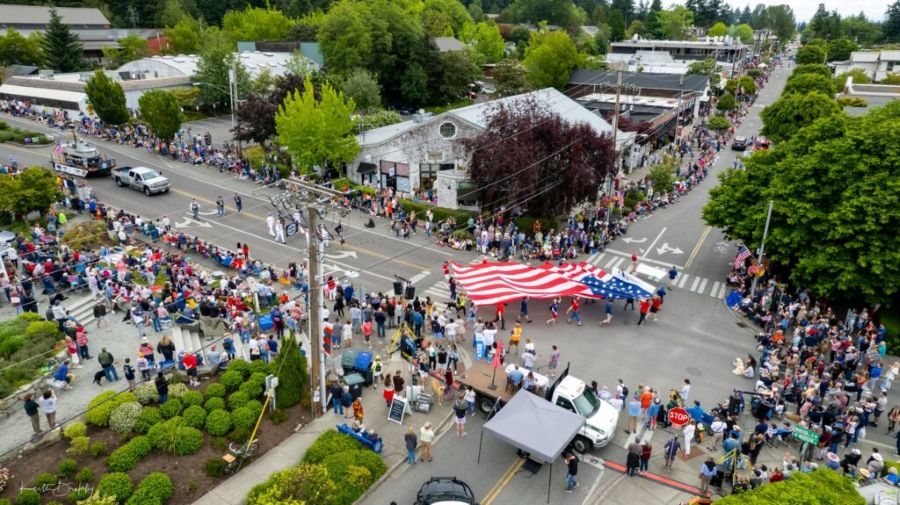 aerial view of Bainbridge Island parade with a large flag for Fourth of July
