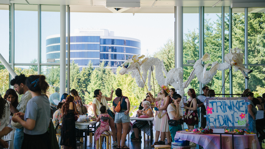 families enjoying a dragon puppet walking through Summer at SAM programming