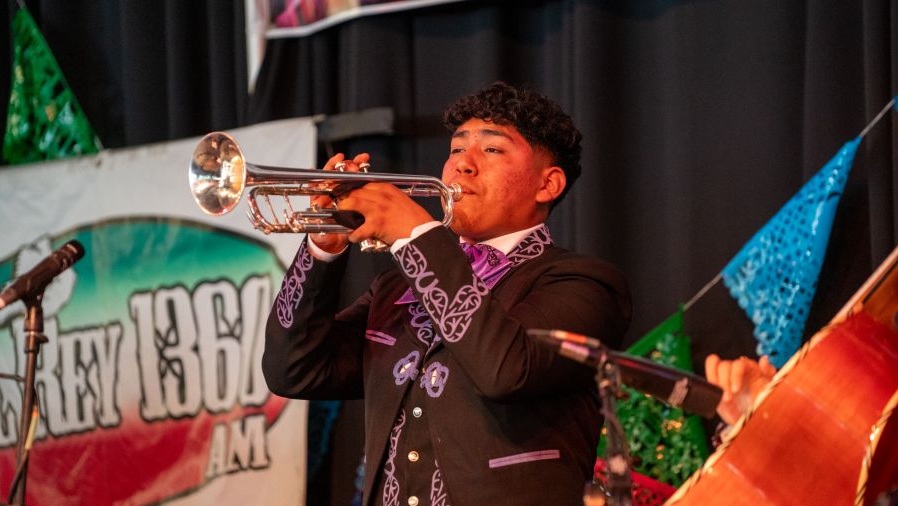 A musician blows a trumpet during the Seattle Center's Fiestas Patrias.