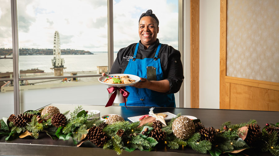 Chef Danielle Grogan posing with decorated cookies during Gold Finch Tavern cookie decorating class for the holidays