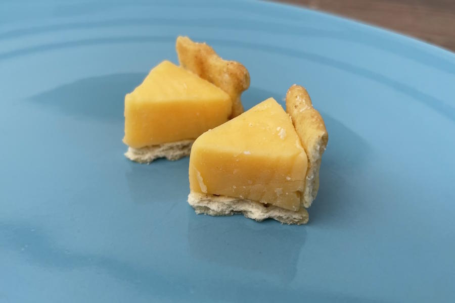 Small crackers with cheese triangles that look like tiny pieces of pie