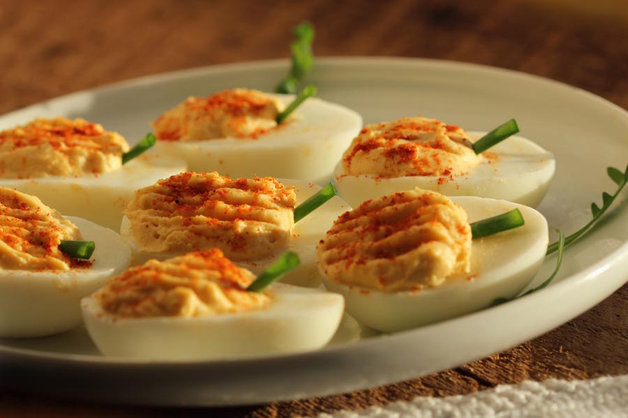 Deviled eggs decorated to look like pumpkins for a Thanksgiving starter for kids