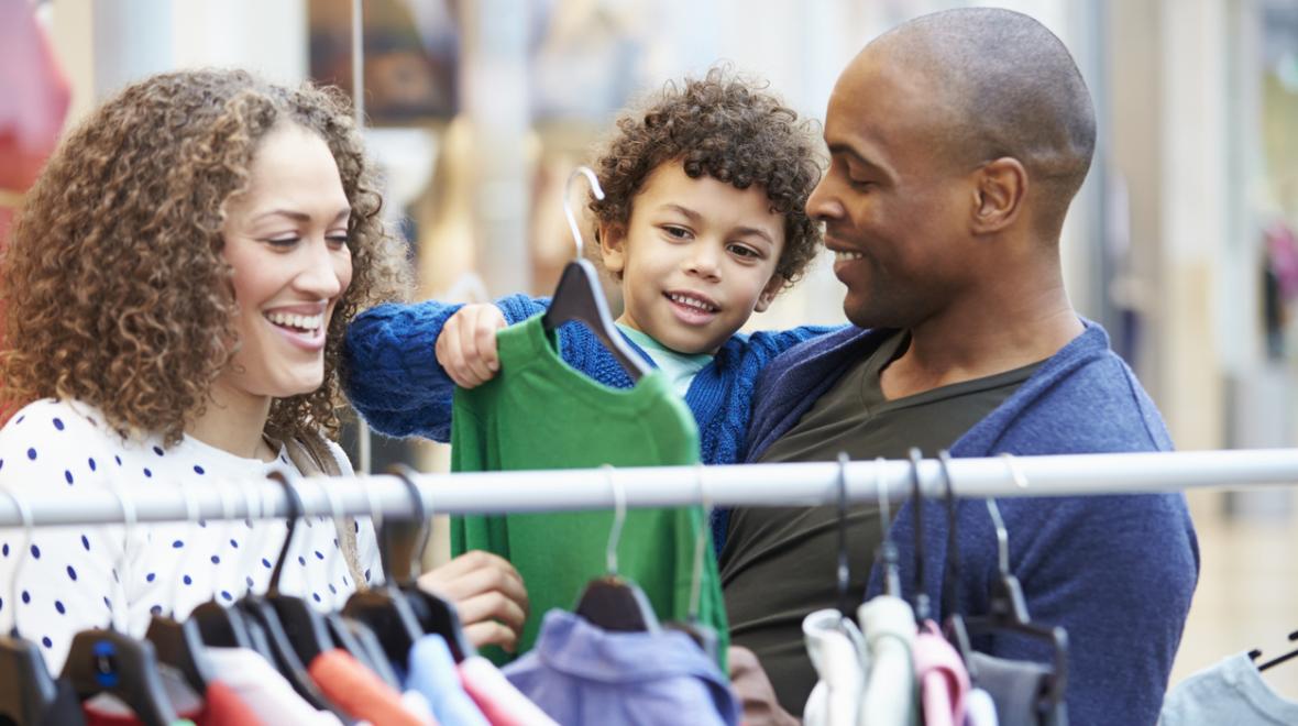 A couple with a young boy out shopping for clothing