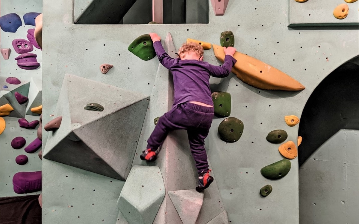 kid on a bouldering rock climbing wall at Seattle Bouldering Project a tot-sized outing for when you need to get home in time for school pick up