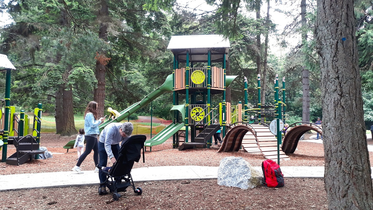 Kids and families play on the updated playground at Discovery Park, Seattle's largest park