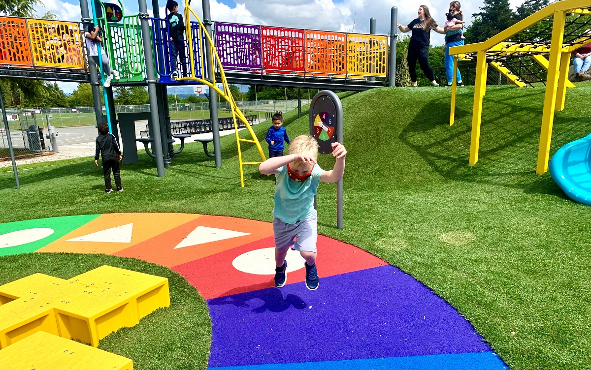 Boy running at new West Fenwick Park Playground