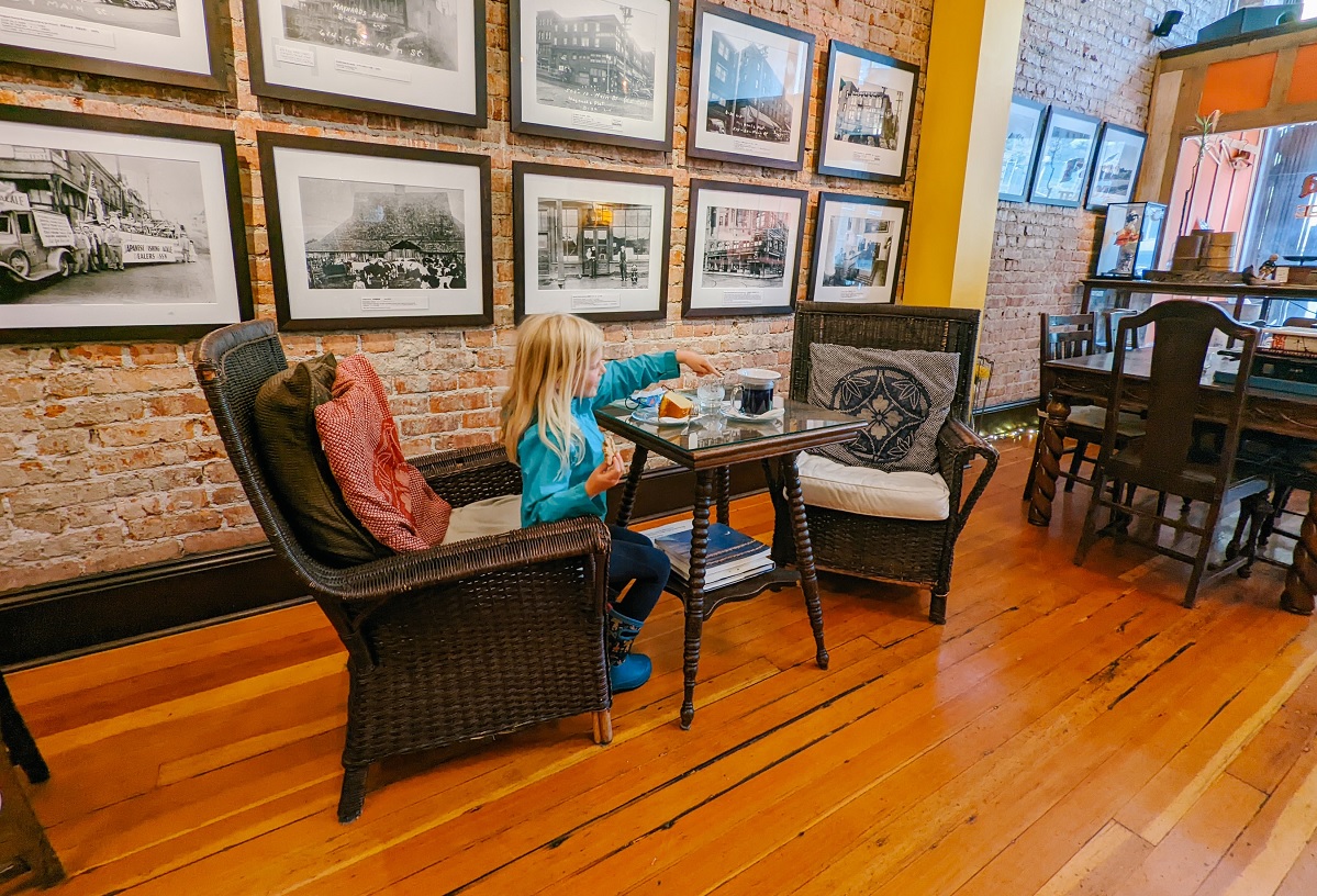 Child sitting at a table having afternoon tea in Seattle at the Panama Hotel and Tea House