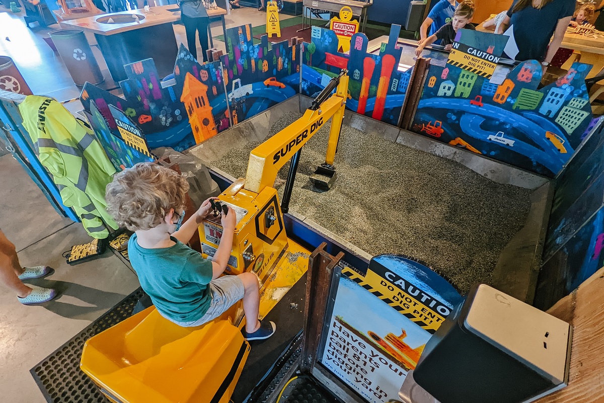 Children playing with a toy digger at Mobius Discovery Center in Spokane, WA.