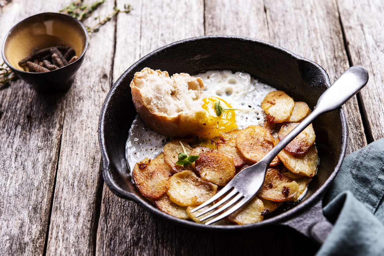 Eggs, toast and potatoes in a cast iron skillet