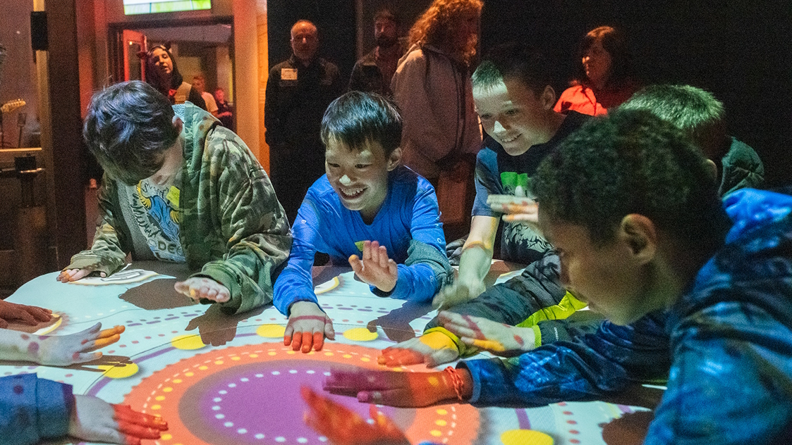 Children smiling and having fun at the Sensory-Friendly Program at the Museum of Pop Culture