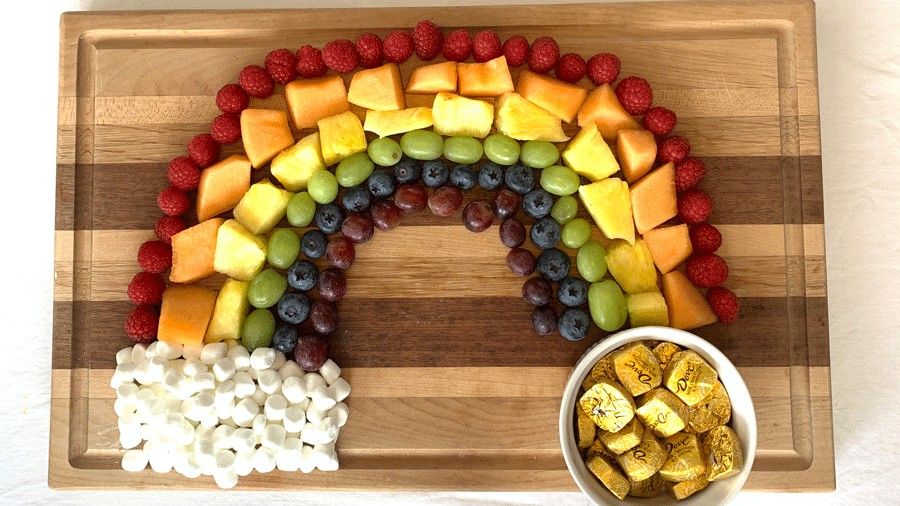 fruit arranged in the shape and colors of a rainbow