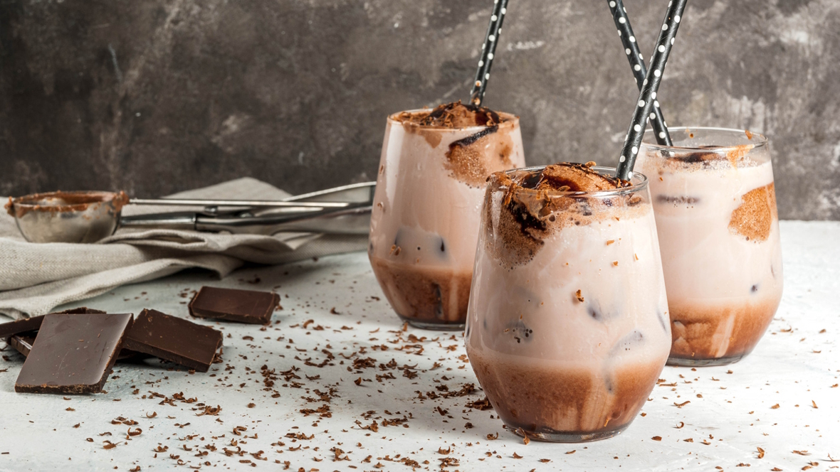 Frozen hot chocolate in glasses with black straws with white polka dots