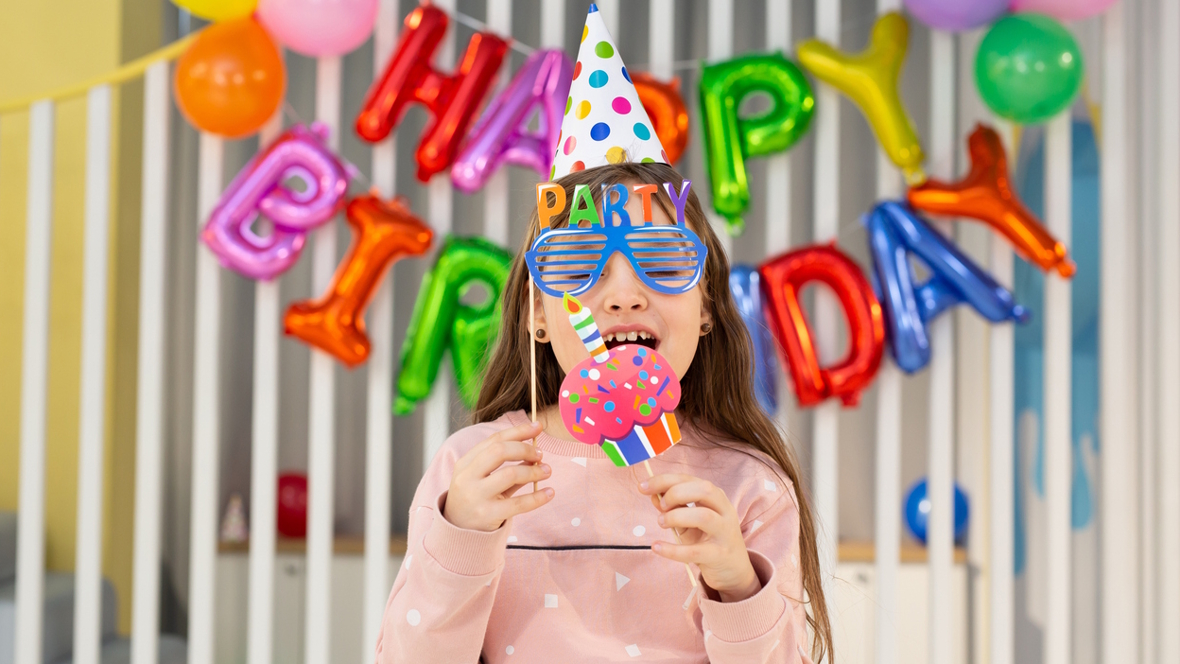 girl in a photo booth at a birthday party