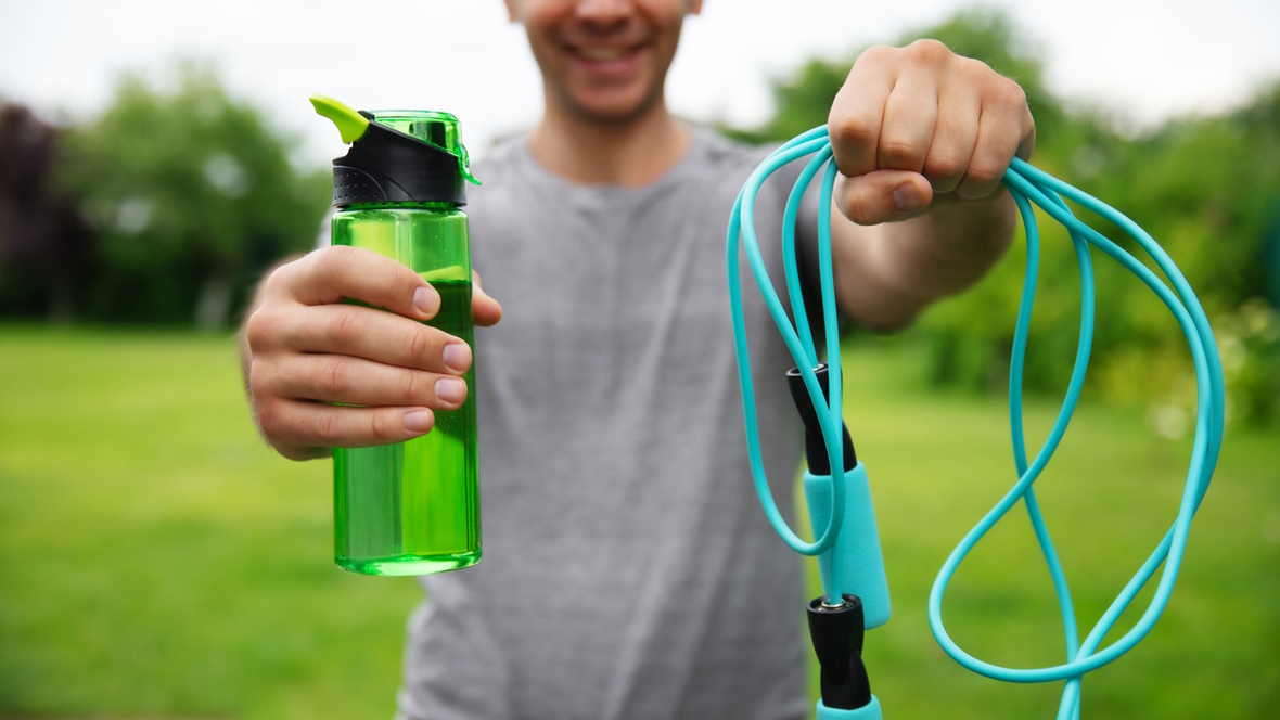 person holding a jump rope and water bottle