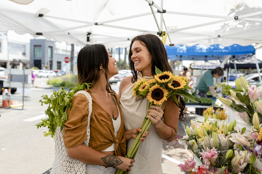 couple at a local farmers market buying flowers having a summer date night