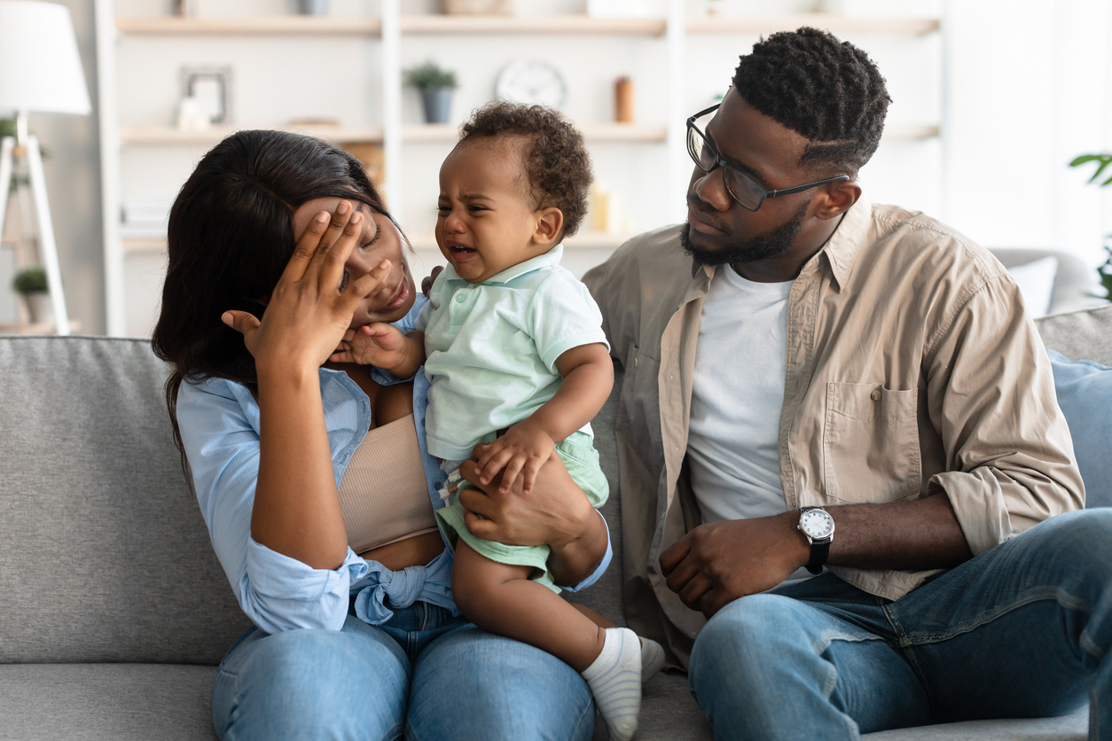 Parents holding a crying baby