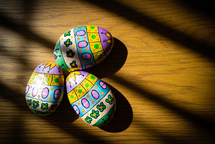 pile of painted rocks that look like Easter eggs.