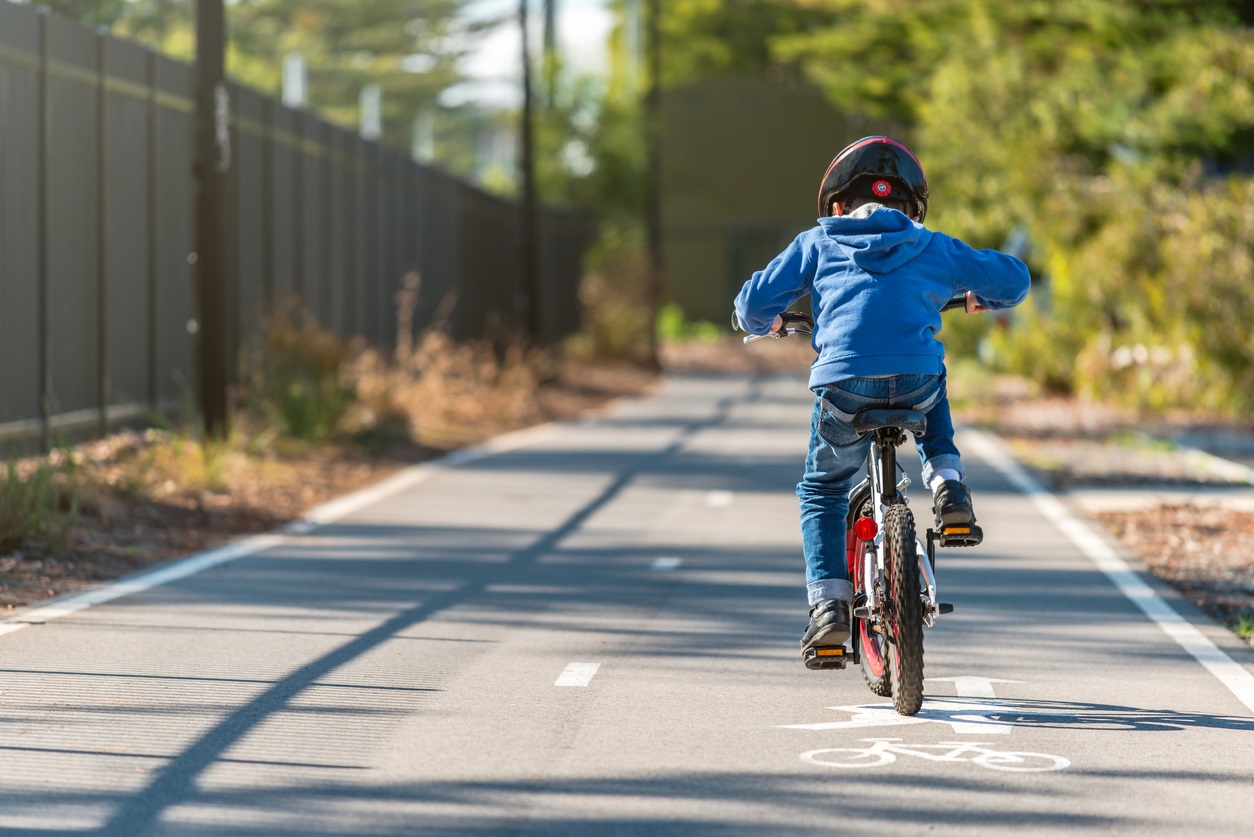Boy learning to ride a bike on a bike path in Seattle