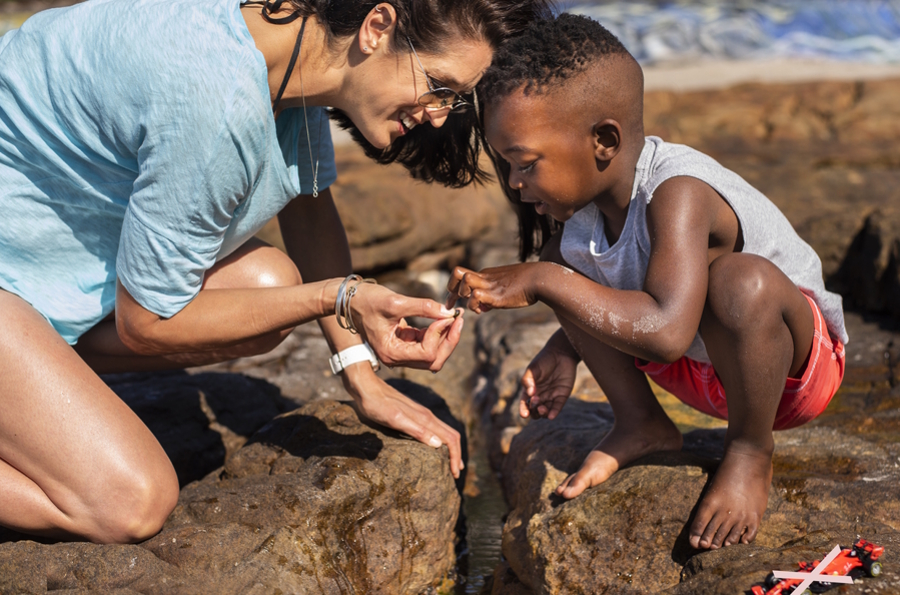 mom and son looking at a tide pool