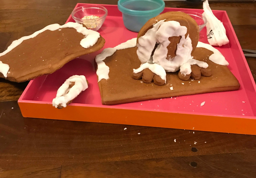 Pieces of a gingerbread cookie shaped like a turkey sitting on a table covered in frosting