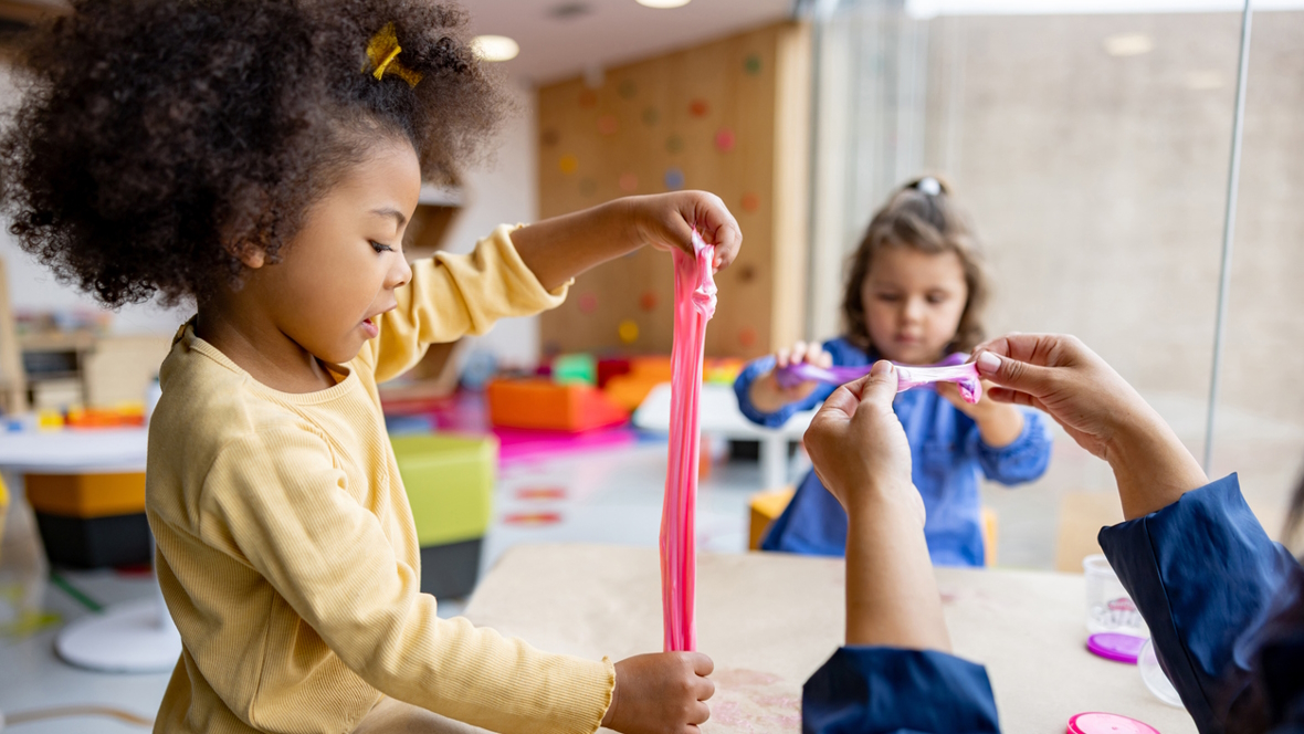 Co-op preschool child playing with slime in a preschool classroom