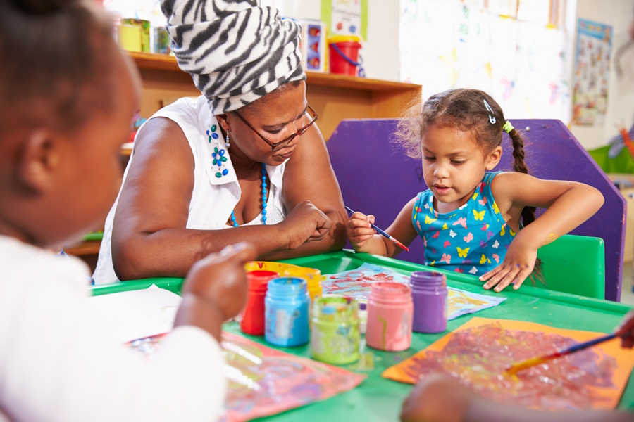 Co-op preschool parent helping at at art table