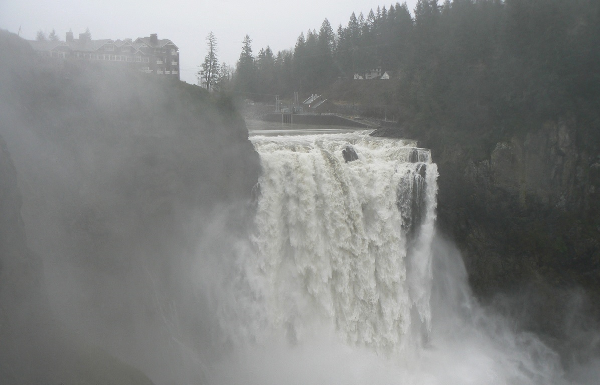 View of famous Snoqualmie Falls near Seattle in gray weather with heavy flow over the falls best places to experience stormy weather around Seattle