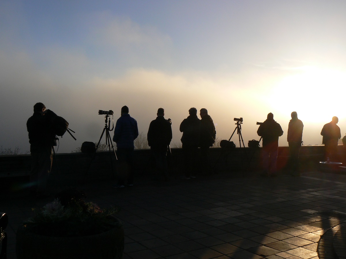 A row of photographers wait to get the best shot from Seattle's Kerry Park overlooking downtown best places to appreciate stormy weather with kids around Seattle