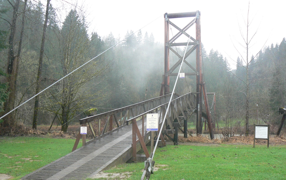 Tolt-McDonald Park suspension bridge in the eastside suburbs of Seattle show in foggy conditions best places to see stormy weather with kids