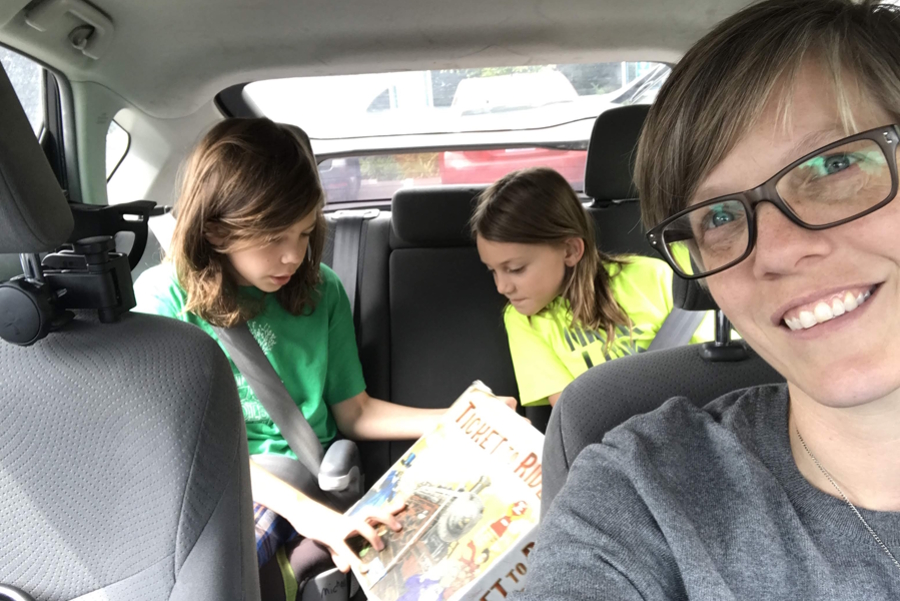 mom and her two sons in the back seat of a car on a roadtrip