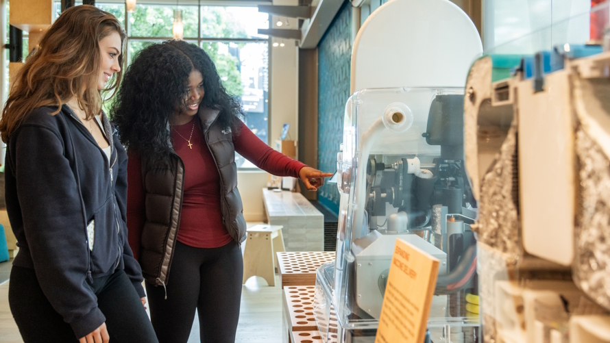 Two women learning about toilets and sanitation at the Gates Foundation Discovery Center