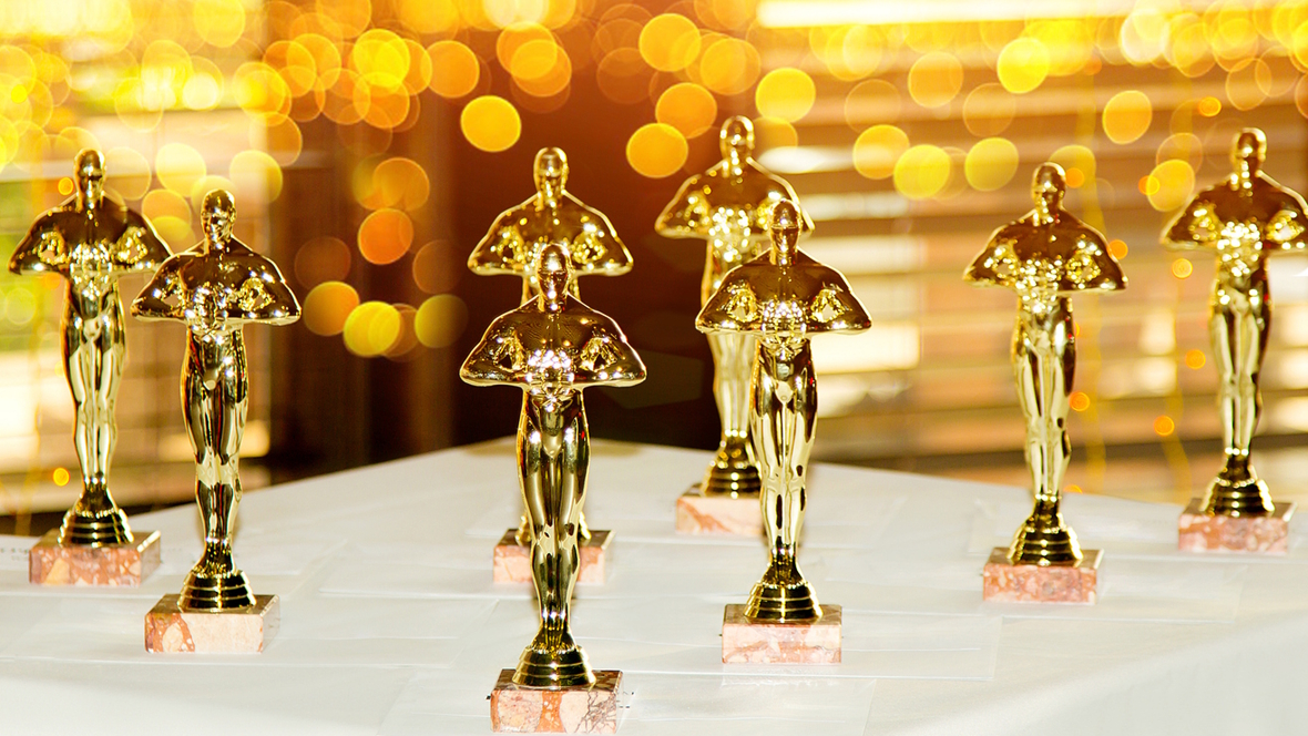 collection of Oscar statues on a table