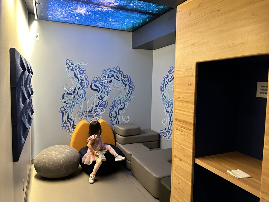 A girl having a quiet moment in a sensory room at SEA airport