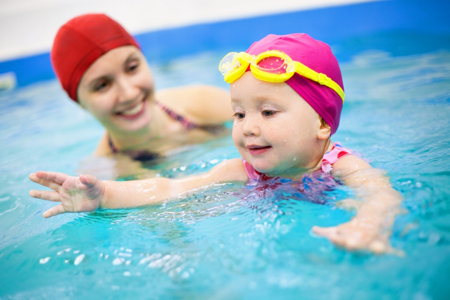 Baby in a swimming lesson