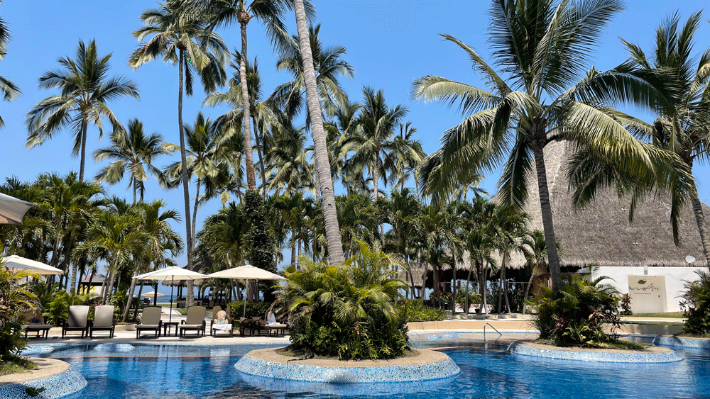 Pools at the Westin Puerto Vallarta hotel have blue mosaic tile and palm trees on islands