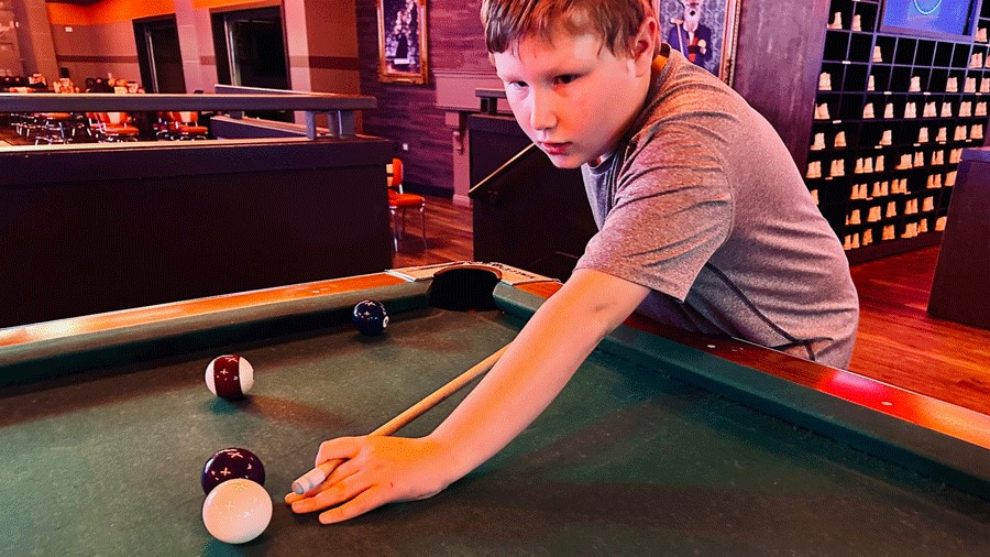 Young boy playing billiards in Seattle