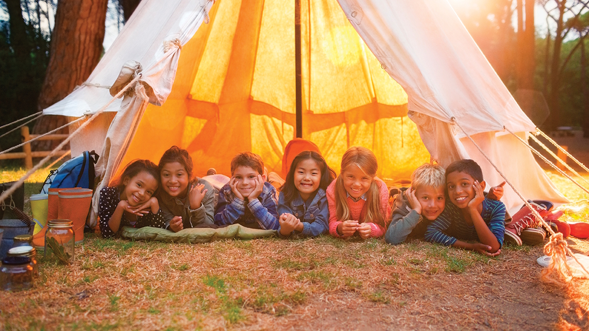 kids in a tent outside during the summer