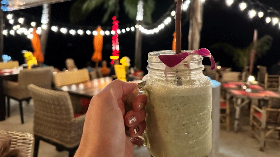 holding a fresh smoothie at Secret Garden Restaurant, one of the best places in Samui to eat