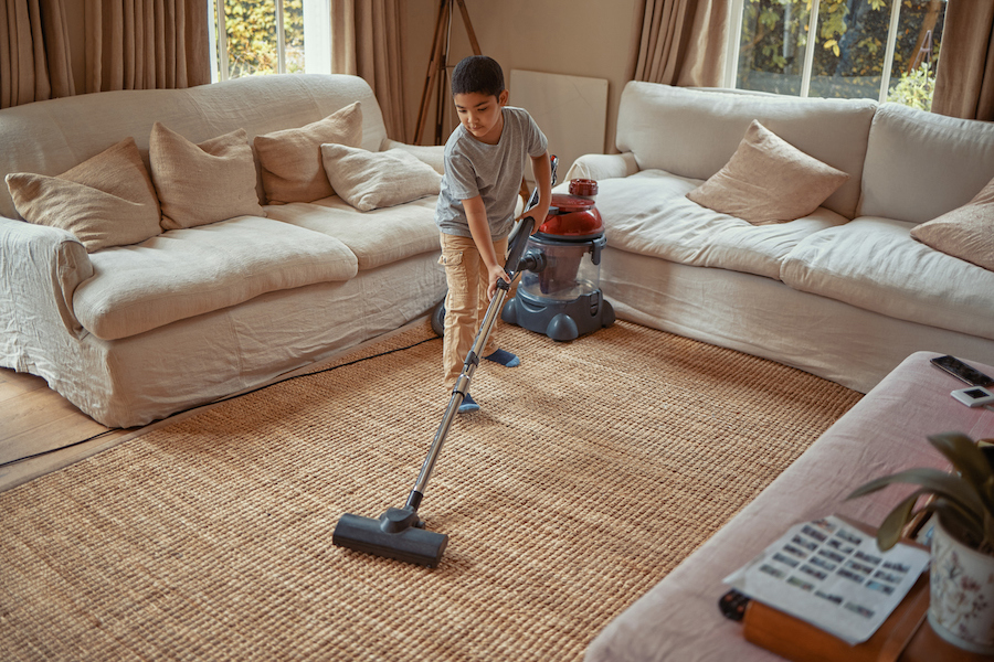 child vacuuming their room