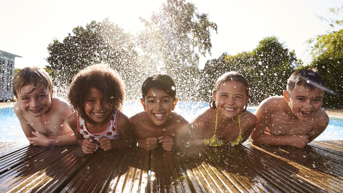 kids swimming in a pool outside