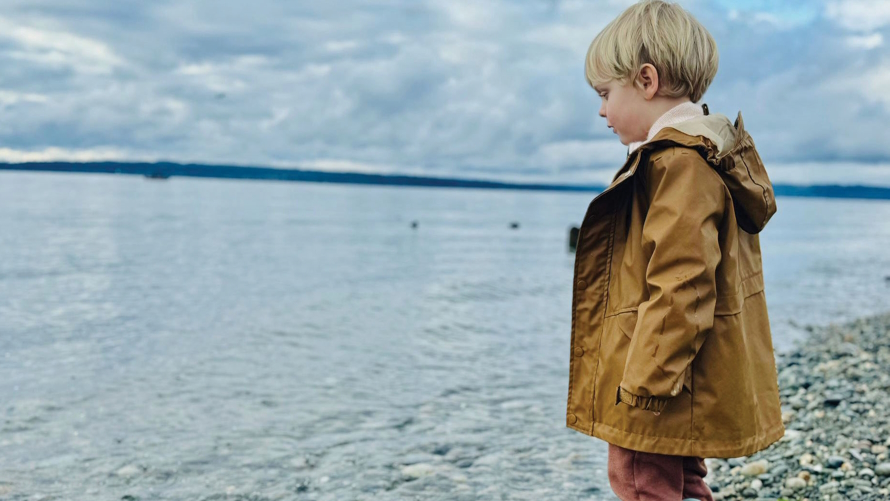 Child throwing rocks at Richmond Beach Saltwater park in Shoreline