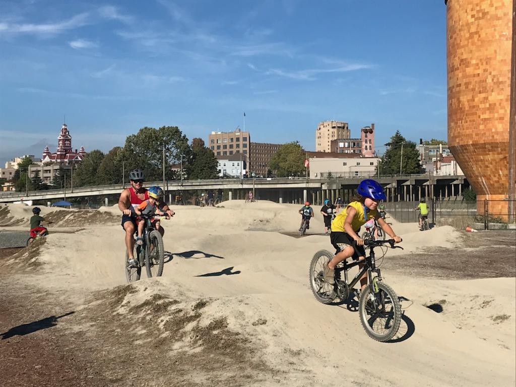 Kids ride on the Waypoint Park pump track in Bellingham, Wash., pump tracks fun summer activity